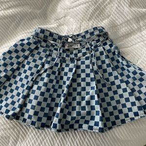 Never worn denim skirt. Checker print pleated skirt. Size small with tags.